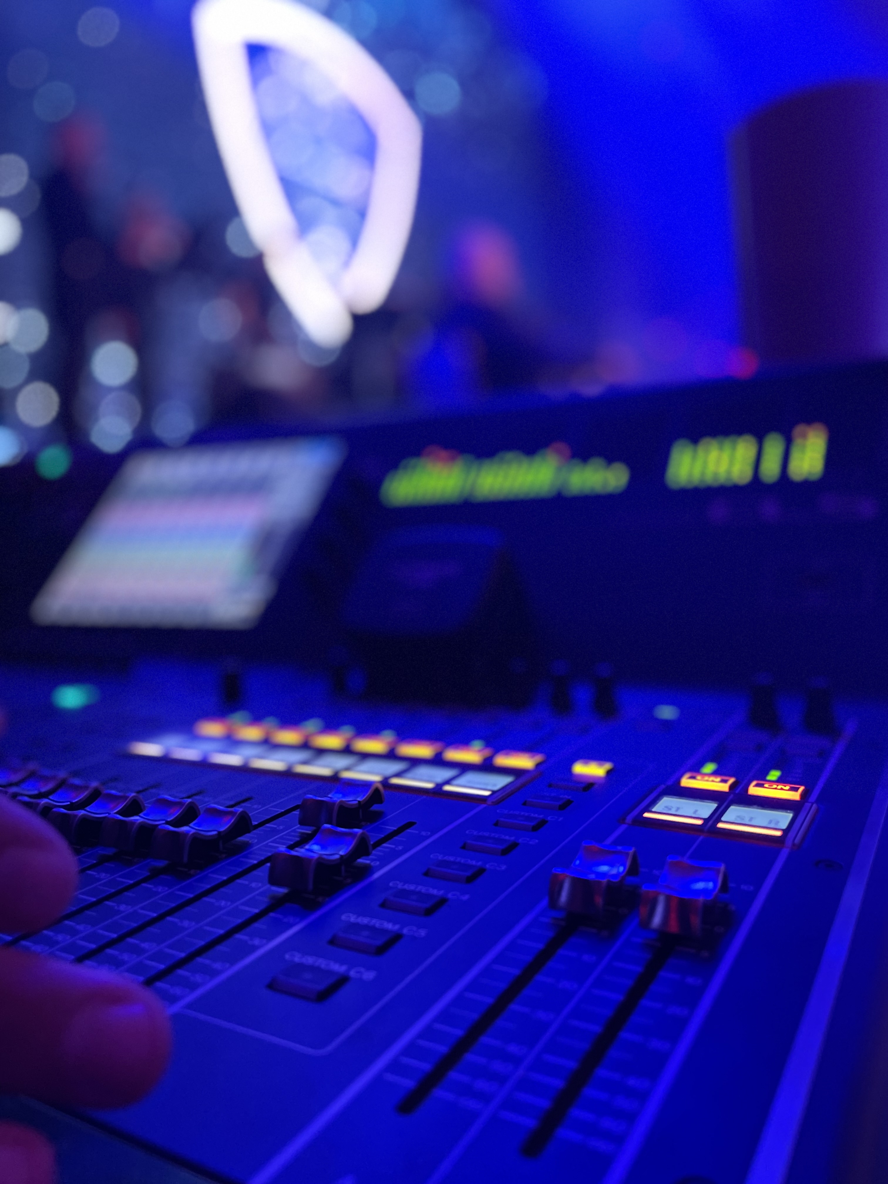 Mixer faders closeup with blue stage lighting